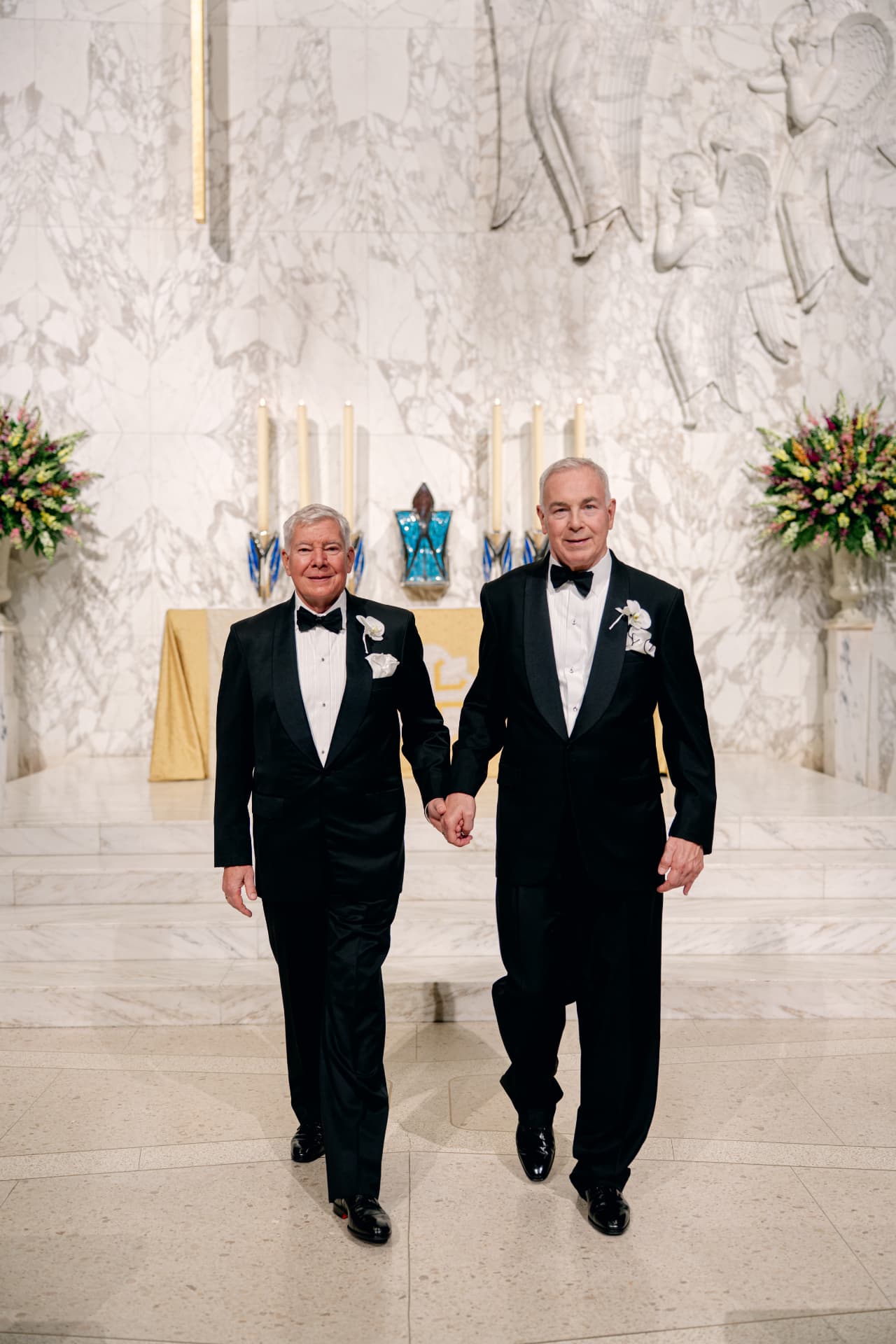 Chuck and John walking hand in hand at the altar of their church