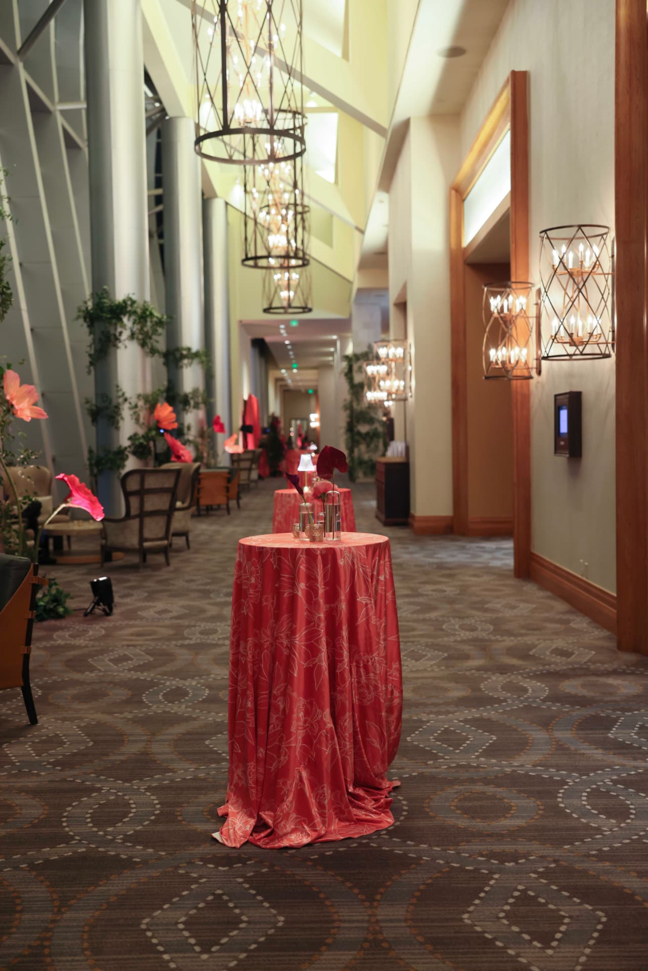 A red-clothed cocktail table in a lamplit hallway at the FWSO gala